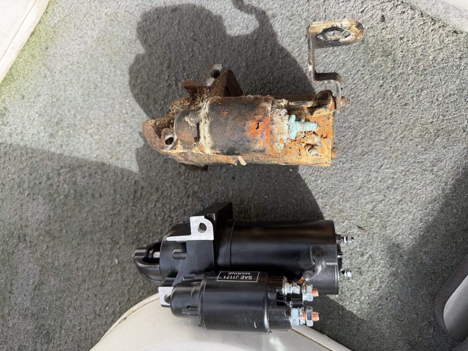 Replacement starter motor beside the original