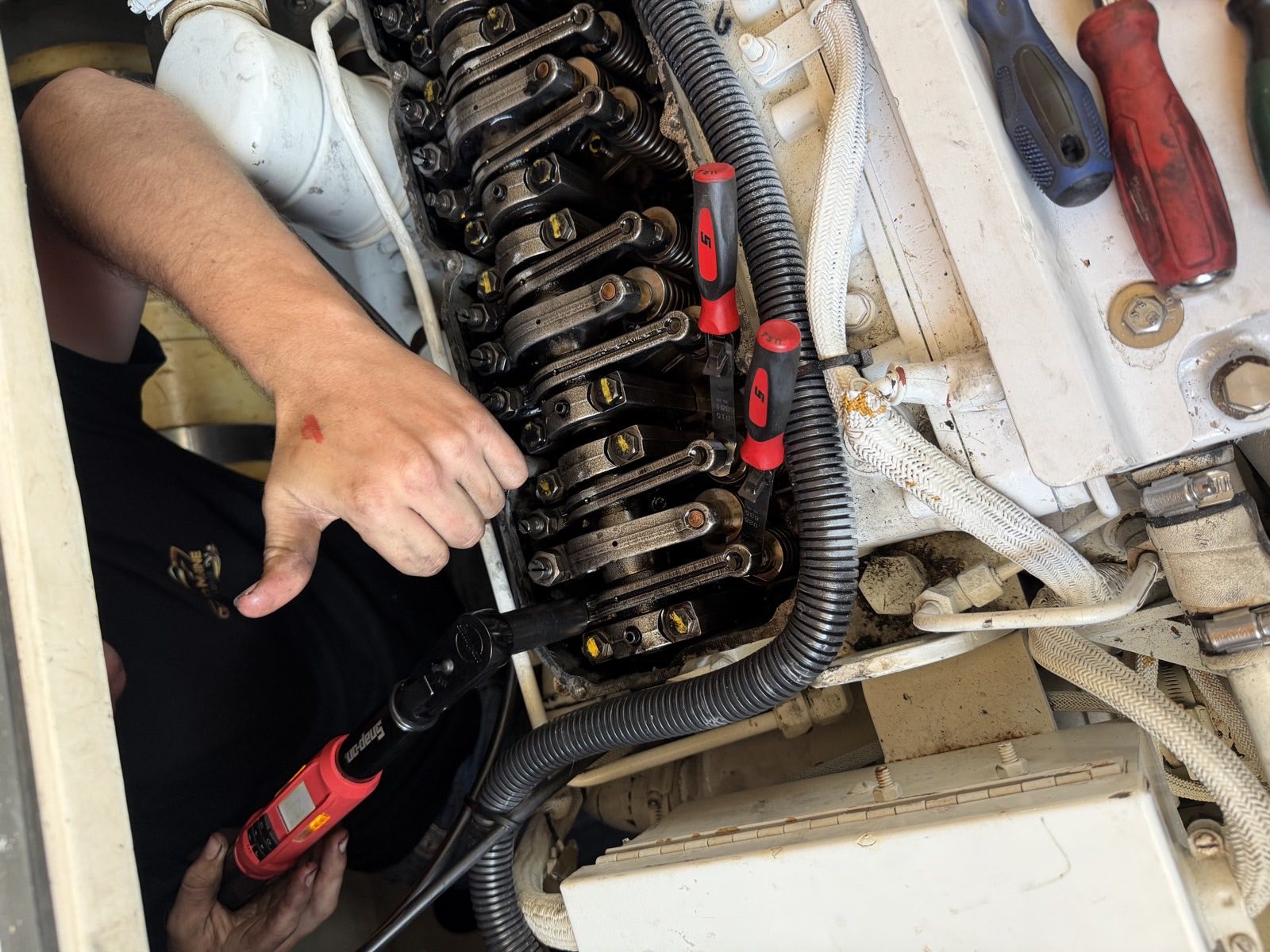 Torque wrench in use on marine engine valve gear with the cover removed