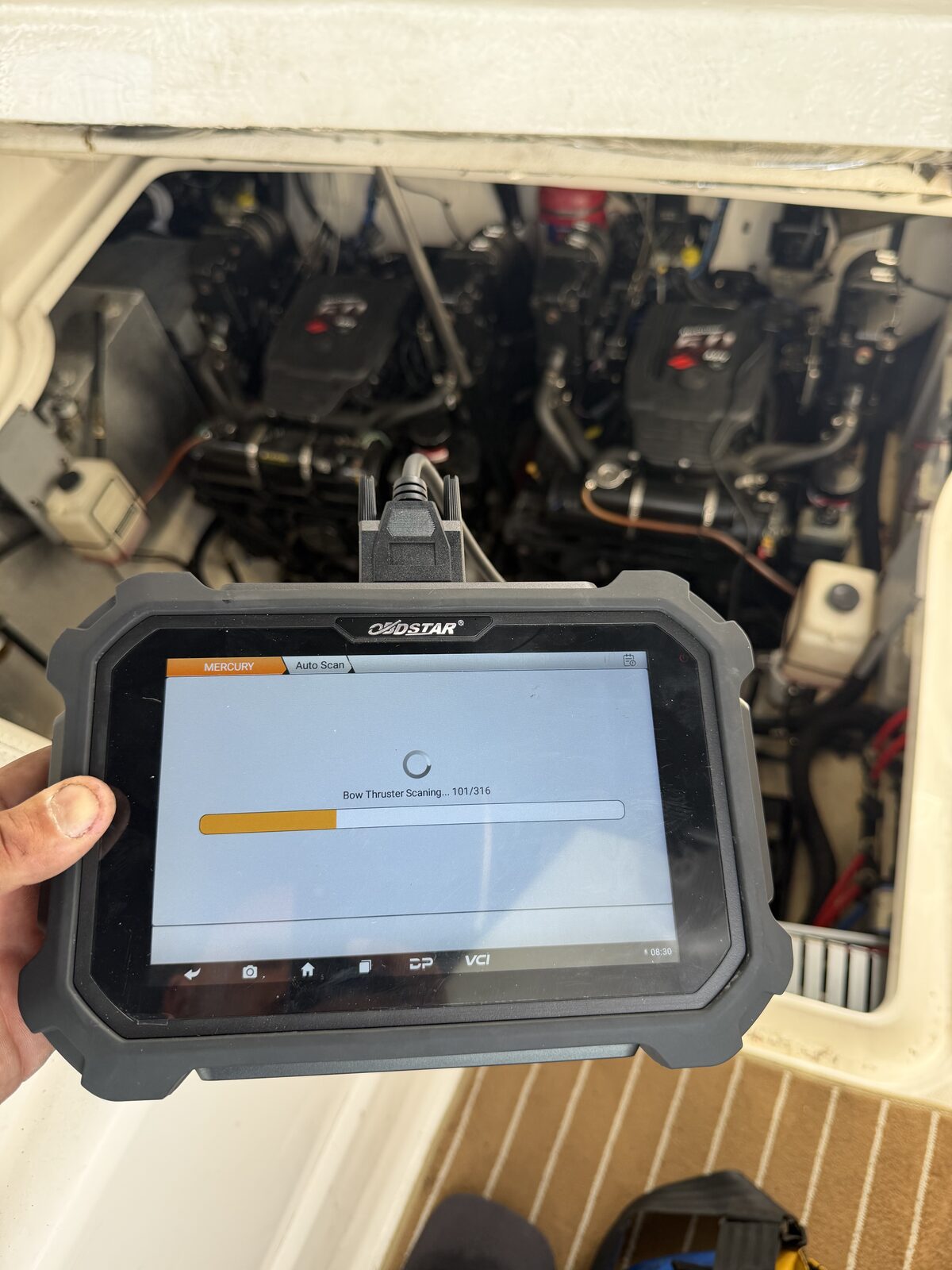 Modern marine diagnostic tool plugged into a marine engine